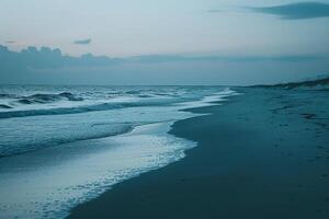 Person Walking on Beach at Dusk with Ocean Background photo