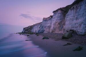 A Beach with Cliffs and Water at Dusk, Background of a Beach with Cliffs and Water at Dusk photo