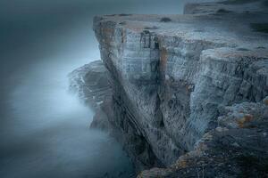 A Long Exposure Photograph of a Cliff with Water photo