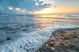 A Beach with Waves and Shells at Sunset photo