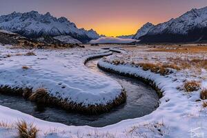A River Flows Through a Snowy Field at Sunset Background photo