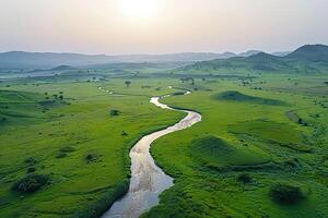 Aerial View of River Flowing through Green Valley Background photo