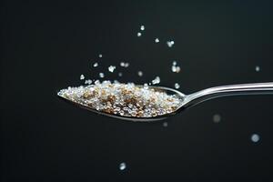 Spoon Full of Sugar Being Poured into a Glass photo