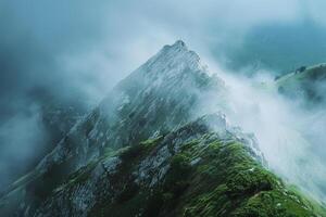 A Mountain with Fog and Clouds Over It Background photo