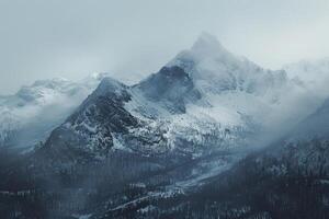 A Snowy Mountain Range Seen in the Fog Background photo