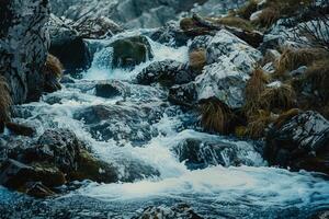 A Stream of Water Flowing over Rocks in the Mountains Background photo