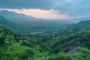 a view of the mountains and green hills at sunset background photo