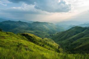 a view of a mountain range with a grassy hill background photo