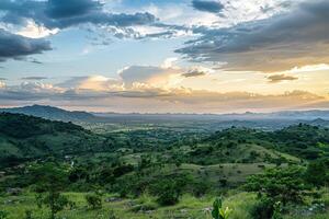 a view of a valley with a mountain in the background background photo