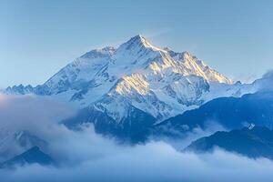 a mountain covered in clouds and snow with a nature background photo