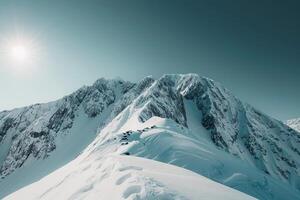 a mountain range with snowcovered mountains and a sun with a nature background photo
