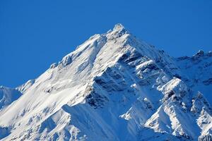 a large snowcovered mountain with a nature background photo