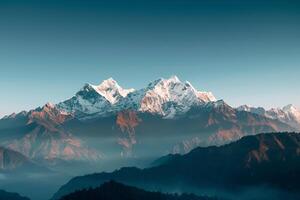 the mountains are covered in snow and fog background photo