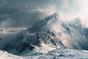A mountain range is shown with snow and clouds background photo