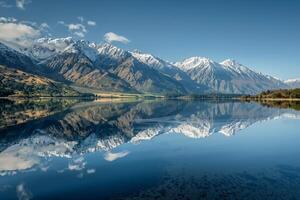 a mountain range is reflected in a lake background photo