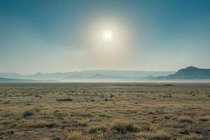 A Large Open Field with the Sun Shining Through the Clouds with a Scenic Background photo