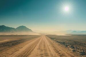 A Dirt Road in the Desert with the Sun Shining with a Scenic Background photo