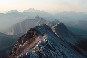 A Mountain Range with a Person Standing on Top with a Scenic Background photo