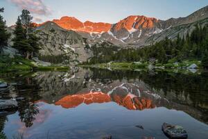 The Mountains are Reflected in the Water of a Lake in the Background photo