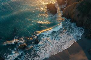 an aerial view of the ocean and beach at sunset background photo