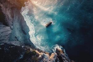 an aerial view of the ocean and rocks background photo