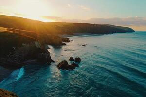 the sun is setting over the ocean and cliffs background photo