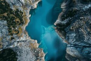 an aerial view of a blue lake in the mountains background photo