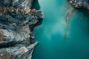 aerial view of a blue lake in the middle of a mountain background photo
