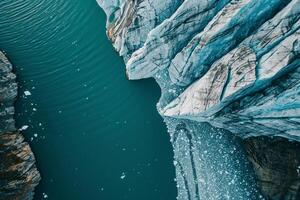 an aerial view of a glacier with water flowing through it background photo