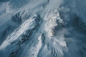 an aerial view of a mountain covered in snow background photo