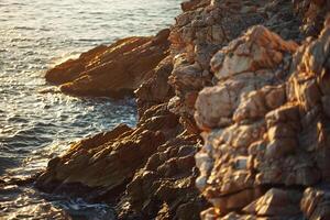 a person standing on a rocky cliff overlooking the ocean with background photo