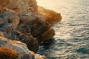 a view of the ocean and cliffs at sunset with background photo