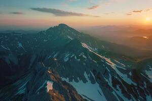 A mountain range with the sun setting over it background photo