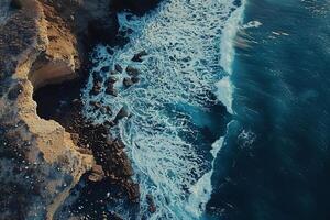 an aerial view of the ocean and cliffs background photo