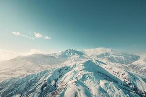 an aerial view of a snowy mountain range background photo