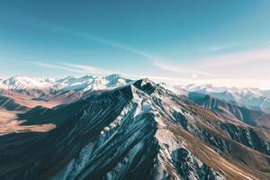 an aerial view of a mountain range with snow capped peaks background photo