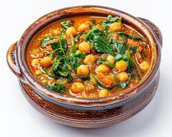 a bowl of stew with spinach and chickpeas background photo