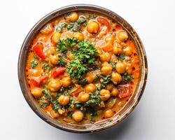 chickpea curry with spinach and tomatoes in a bowl background photo