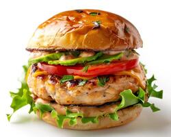 a hamburger with cheese, tomato, lettuce and avocado photo