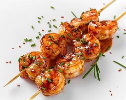 shrimp skewers with sauce and herbs on a white plate photo