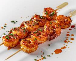 shrimp skewers with sauce and garnish on a white surface photo