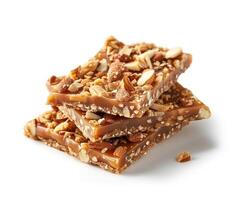 a pile of caramel and nuts on a white background photo