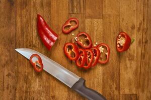 Slices of red pepper on a cutting board photo
