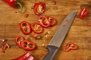 Slices of red pepper on a cutting board photo