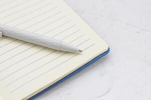 The pen lies in the notebook, the concept of study, time management. photo