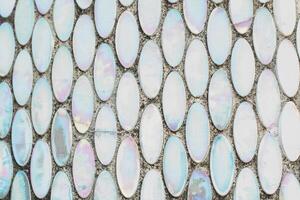 Texture of mother-of-pearl mosaic round tiles, close-up photo