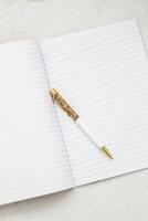 The pen lies in the notebook, the concept of study, time management. photo