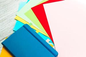 Notebook diary for planning in blue and yellow and colored cardboard for creativity. photo