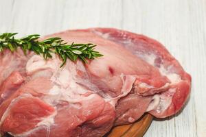 Fresh piece of meat large pork ham on the board. photo