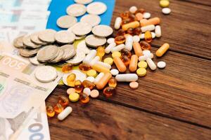 Ukrainian hryvnias with flag of Ukraine with pills and vitamins, healthcare concept photo